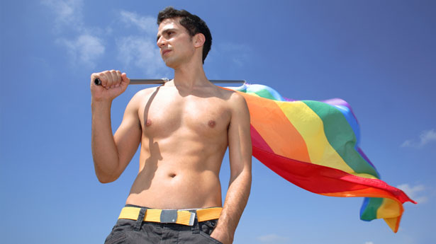 Young-man-with-Gay-Pride-flag-via-Shutterstock